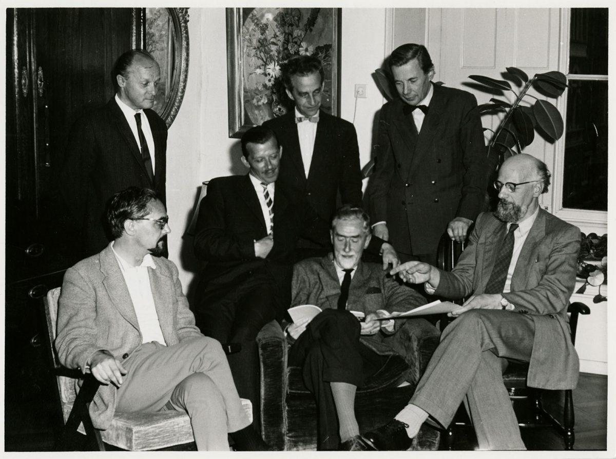 Escher with his fellow board members of 'De Grafische', July 1960. From left to right, standing: Gerd Arntz, Jan Bezemer, Pam Rueter. Seated: Lou Strik, Cor Basart, M.C. Escher and Hans van Dokkum. For many years Escher was the archivist of this associati