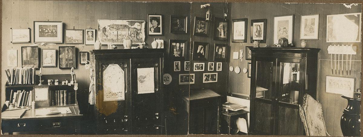 1915: Escher's room in Arnhem, with the reproduction of The Sampling Officials in the upper left corner.