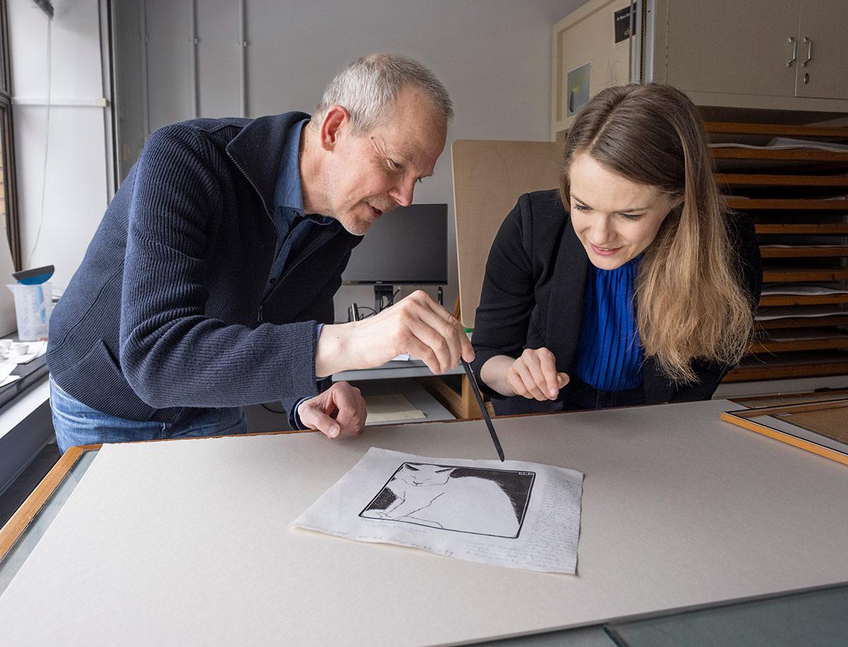 Paper conservator Paul van der Zande and curator Judith Kadee at White cat in the conservation studio of Kunstmuseum Den Haag